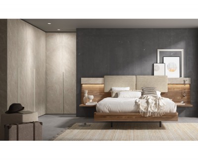 Chambre avec lit double avec tête de lit tapissée, tables de chevet et armoires